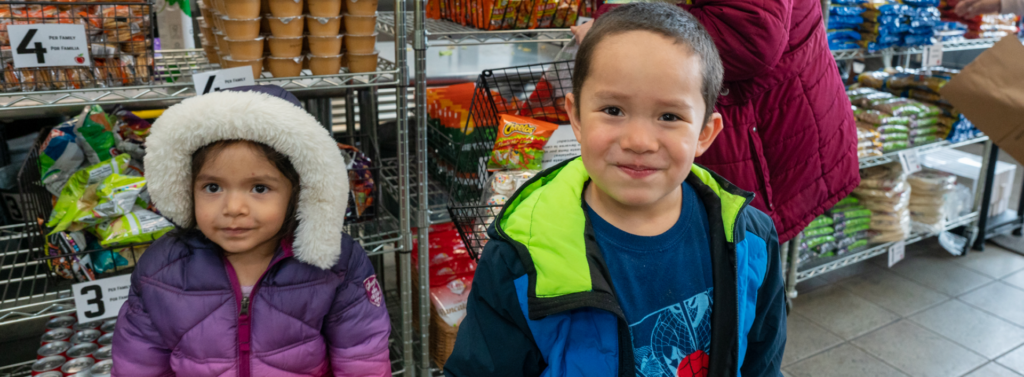 Two children shopping with their mother at Eagle Valley Community Market 